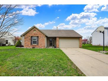 Charming brick home with a well-manicured lawn and attached two-car garage at 8312 Eagles Nest Dr, Avon, IN 46123