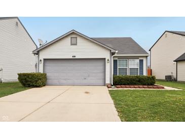 Charming single-story home with a two-car garage, neat landscaping, and inviting curb appeal at 10861 Tealpoint Dr, Indianapolis, IN 46229