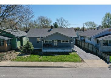 Charming one-story home with a cozy front porch and well-manicured lawn at 1125 N Colorado Ave, Indianapolis, IN 46201