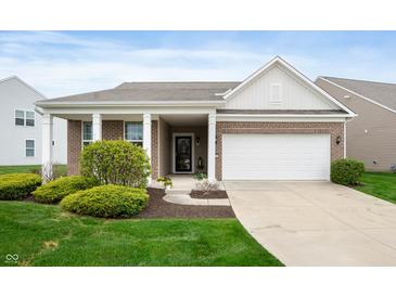 Charming single-story home featuring a brick facade, covered porch, and attached two-car garage at 12914 Shiraz Ln, Fishers, IN 46037