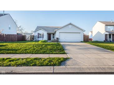 Charming single-story home with a well-maintained lawn and a paved driveway leading to the garage at 1696 Carlton Dr, Greenfield, IN 46140