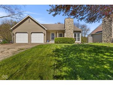 Charming single-Gathering home featuring a two-car garage and a stone chimney at 1736 Sandoval Ct, Indianapolis, IN 46214