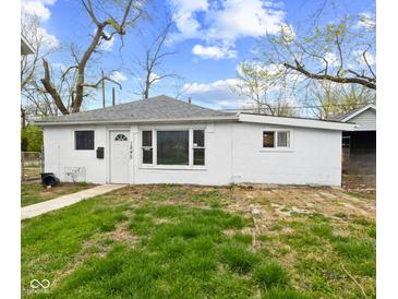 Quaint single-story home featuring a well-lit exterior, a gray roof and a manicured lawn at 1842 W Kessler Blvd N Dr, Indianapolis, IN 46228
