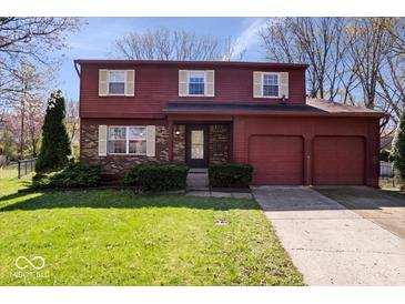 Charming two-story home featuring a two-car garage, brick and wood siding, and a well-maintained front lawn at 315 Heritage Ct, Fishers, IN 46038