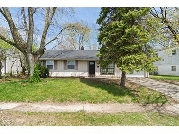 Charming single-story home with a well-maintained lawn, mature trees, and inviting curb appeal at 3703 Dubarry Rd, Indianapolis, IN 46226