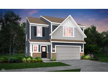 Charming two-story home with attached garage, and professionally landscaped front yard at 4105 Ashton View Ln, Indianapolis, IN 46268