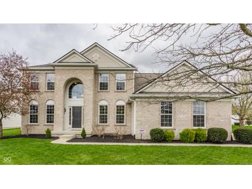 Two-story brick home featuring a manicured lawn and arched entryway with large windows at 559 Hythe Way, Westfield, IN 46074