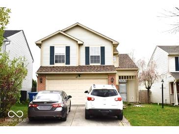Two-story home with vinyl siding, dark shutters, and an attached two-car garage at 607 Deer Trail Dr, Indianapolis, IN 46217