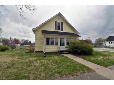 Charming yellow two-story home with a cozy front porch and well-maintained lawn at 609 E Columbus St, Martinsville, IN 46151