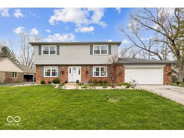 Charming two-story home featuring brick and siding, complemented by a well-maintained lawn and landscaping at 6133 Buttonwood Dr, Noblesville, IN 46062