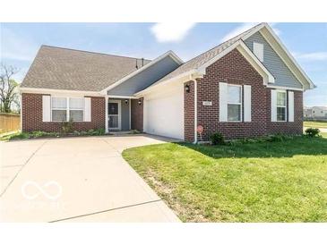 Charming brick home featuring a well-manicured lawn and an inviting front entrance at 6479 Enclave Blvd, Greenwood, IN 46143