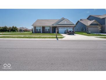 Charming single-story home featuring a brick facade, attached garage, and well-manicured front lawn at 7209 Glen Park Ln, Indianapolis, IN 46259