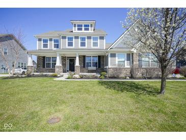 Beautiful two-story home with large front yard, manicured landscaping, and inviting curb appeal at 15594 Garrano Ln, Fishers, IN 46040