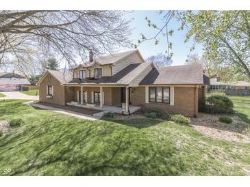 Charming brick home with a cozy front porch and lush green lawn at 1772 Woodridge Pl, Greenwood, IN 46143