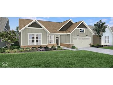 Charming single-story home with gray siding, complemented by a well-manicured lawn and inviting landscaping at 19414 Mcbee Ave, Westfield, IN 46074