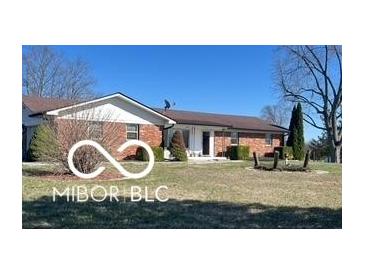 Charming brick home featuring a well-maintained front yard and mature landscaping at 2227 S County Road 300 E, Danville, IN 46122