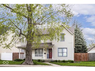 Charming two-story home with a well-maintained front yard and inviting red front door at 2615 N Delaware St, Indianapolis, IN 46205
