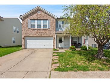 Charming two-story home with a brick and siding exterior and a well-maintained front yard and a two-car garage at 350 Springfield Cir, Greenwood, IN 46143