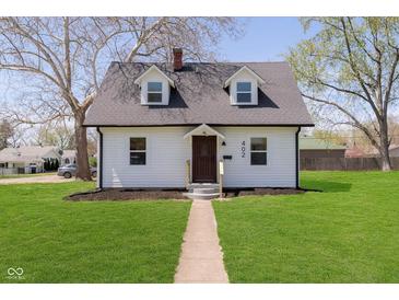 Charming two-story home featuring a manicured lawn, light siding, and a welcoming pathway to the front door at 402 N 19Th Ave, Beech Grove, IN 46107