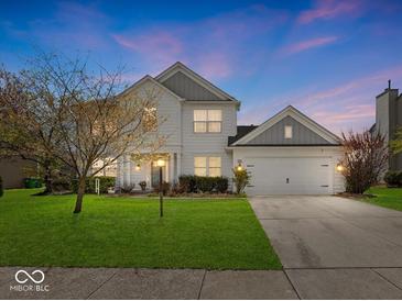Charming two-story home with a well-manicured lawn, attached two-car garage and inviting curb appeal at 45 Wisteria Way, Westfield, IN 46074
