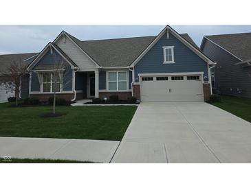 Charming two-story home featuring blue siding, a well-manicured lawn, and an attached two-car garage at 5269 Parkhurst Xing, McCordsville, IN 46055