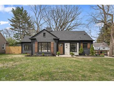Charming home featuring a brick exterior, stylish shutters, landscaping, and a well-maintained front yard at 5954 Crestview Ave, Indianapolis, IN 46220