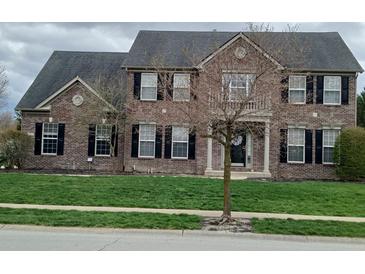 Two-story brick home with black shutters, manicured lawn, and well-maintained landscaping at 5983 Clearview Dr, Carmel, IN 46033