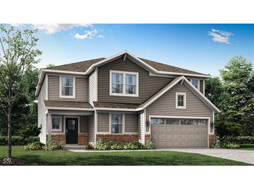 Charming two-story home with a two-car garage, landscaped yard, and inviting entrance at 7230 Estes Dr, Indianapolis, IN 46239