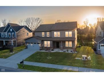 Beautiful two-story home with gray siding, well-manicured lawn, and an attached two-car garage at 9800 Ridgecrest Ln, McCordsville, IN 46055