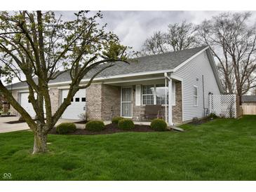 Charming single-story home with well-manicured lawn and inviting front porch at 1008 E Apple Lake Dr, Greenfield, IN 46140