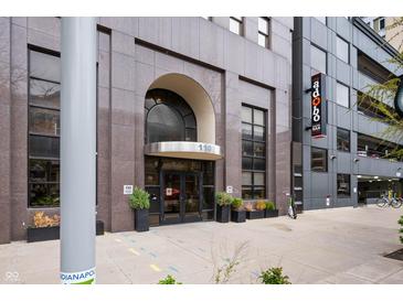 Exterior view of a building entrance with planters and address number '110' at 110 Washington St # 301, Indianapolis, IN 46204