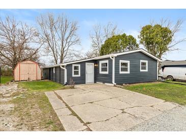 Charming single-story home with a concrete driveway and a quaint storage shed in the yard at 14 Fountain Lake Dr, Greenfield, IN 46140