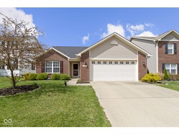 Charming single-Gathering home with brick and siding, a two-car garage, and a well-manicured front yard at 15501 Landsbrook E Run, Noblesville, IN 46060
