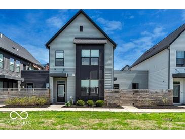 Charming two-story home with modern design elements and a well-manicured front yard at 1712 Rosette Way, Indianapolis, IN 46202