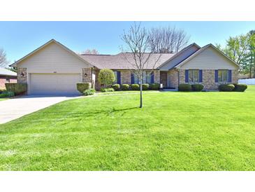 Charming brick home with manicured lawn, neat shrubbery and a welcoming two car garage at 1927 Pheasant Way, Greenwood, IN 46143