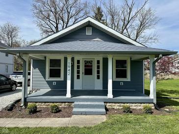 Charming single-story home with a covered front porch, beautiful landscaping, and great curb appeal at 1942 E Edgewood Ave, Indianapolis, IN 46227