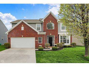 Charming two-story home with a brick facade, attached garage, and manicured lawn at 4546 Creighton Ln, Indianapolis, IN 46237