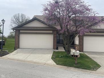 Charming townhome with well-manicured lawn, beautiful trees, attached garages and double mailboxes at 599 Cielo Vista Dr, Greenwood, IN 46143