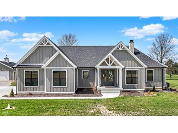 Charming home featuring a manicured lawn, stylish gray siding, and inviting front entrance at 706 E 750 N, Lebanon, IN 46052
