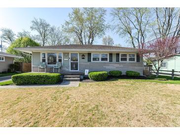 Charming single-story home with well-maintained landscaping, front porch, and inviting curb appeal at 7735 E 50Th St, Indianapolis, IN 46226