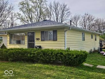 Charming single-story home with a well-maintained lawn and mature hedges at 8412 E 47Th St, Indianapolis, IN 46226