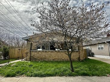 Charming brick bungalow-style home with a well-maintained front lawn at 1020 N Colorado Ave, Indianapolis, IN 46201