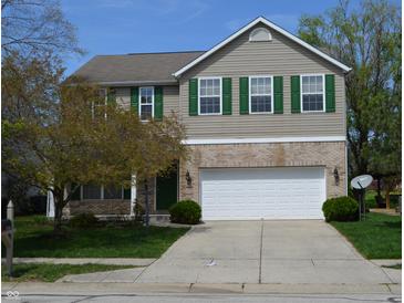 Charming two-story home with attached two car garage, manicured lawn and mature tree at 12326 River Valley Dr, Fishers, IN 46037