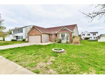 Charming single-Gathering home featuring a well-manicured lawn, brick accents, and an attached two-car garage at 1632 Blankenship Dr, Indianapolis, IN 46217