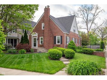Charming brick home with manicured lawn and lush landscaping offers timeless curb appeal at 171 W 44Th St, Indianapolis, IN 46208