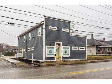 Modern two-story building with gray siding and a unique architectural design on an overcast day at 2329 Shelby St, Indianapolis, IN 46203