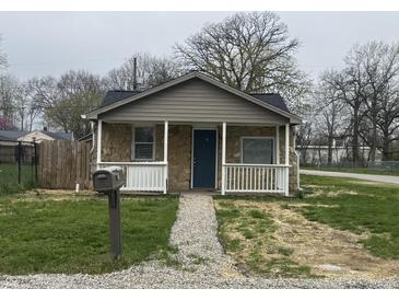 Charming bungalow featuring a stone facade, covered porch, and well-maintained front yard at 3302 S Rybolt Ave, Indianapolis, IN 46221