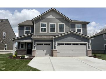 Charming two-story home with a two car garage, light grey siding, and manicured lawn at 4376 Risen Star Way, Bargersville, IN 46106