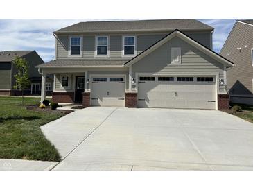 Charming two-story home with a two-car garage, manicured lawn, and neutral colored siding at 4390 Risen Star Way, Bargersville, IN 46106