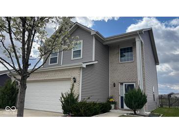 Charming two-story home featuring brick and vinyl siding with an attached two car garage at 530 Farnham Dr, Westfield, IN 46074